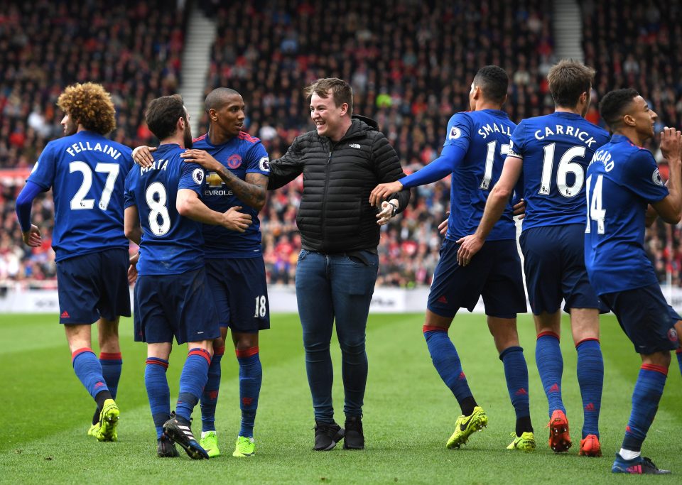  Cheeky pitch invader is all smiles as Jesse Lingard does his dance