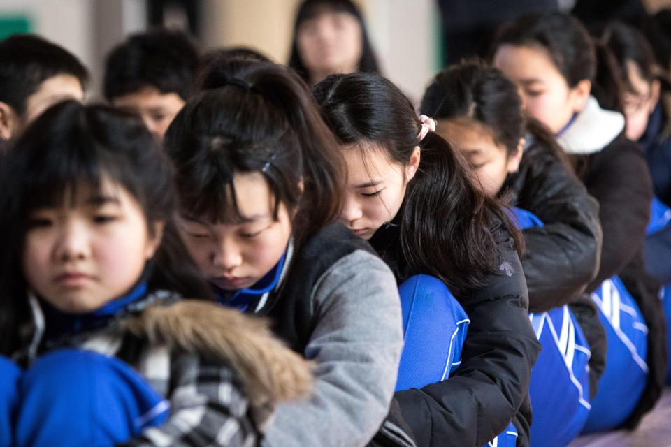  Japanese schoolchildren at the Hokuyou Elementary School listen to instructions of the officials during a missile evacuation drill