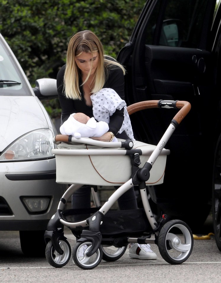 The star cradled her baby before putting him in a pushchair