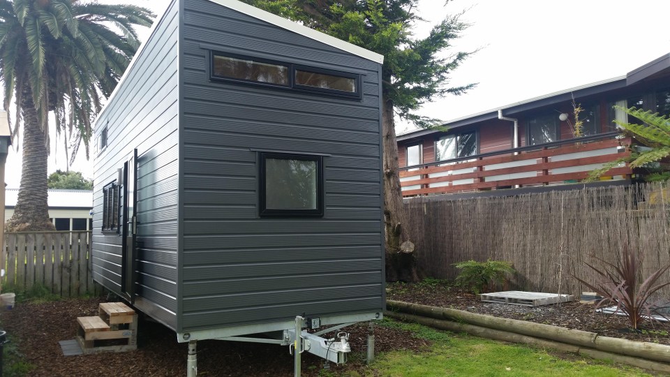 The tiny steel frame home has been built onto a trailer and contains a living room, bathrooms, kitchen and bedroom 