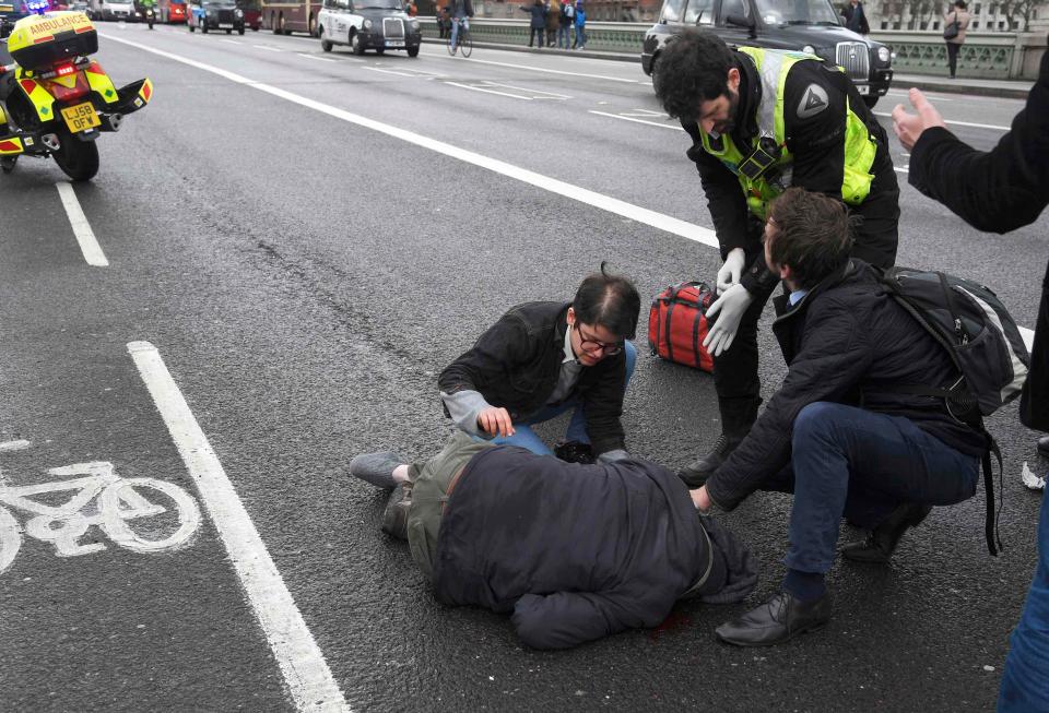  People attending to an injured person at the Westminster Bridge