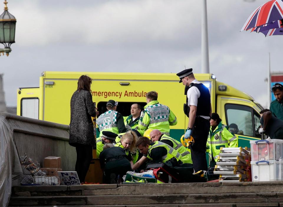  Paramedics treat a victim of the attack on Westminster Bridge