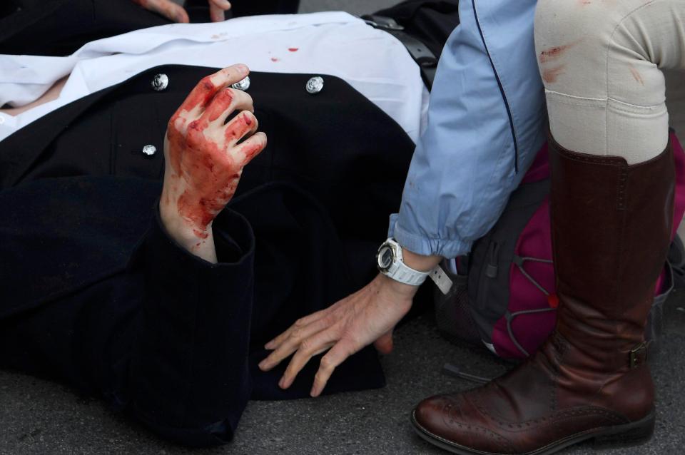  A bloodied victim is pictured at the scene in Westminster