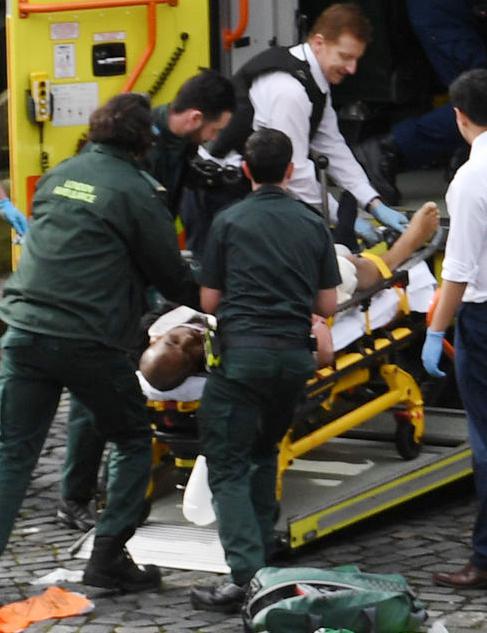  A man - thought to be the terrorist behind yesterday's attack - is wheeled onto an ambulance