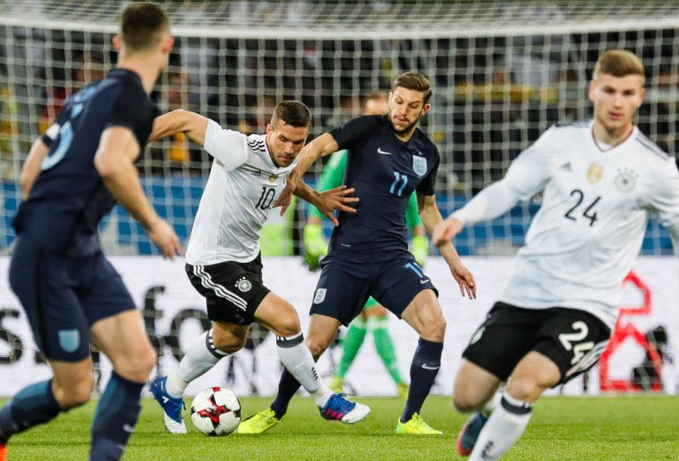  Adam Lallana battled for the ball in the new navy blue kit