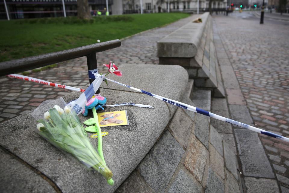  Floral tributes are left to the victim's of yesterday's attack at the security cordon close to Westminster Abbey