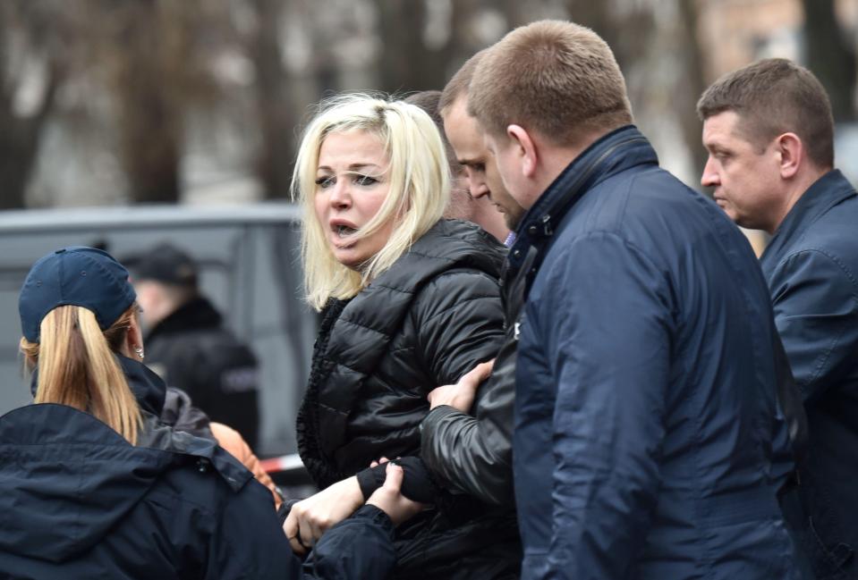  Maria Maksakova, wife of Denis Voronenkov, is led from the scene of her husband's murder in Kiev