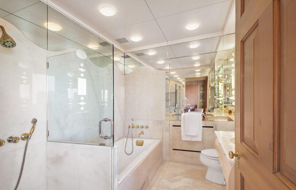 The bathroom is decorated in neutral shades, with marble a prominent feature