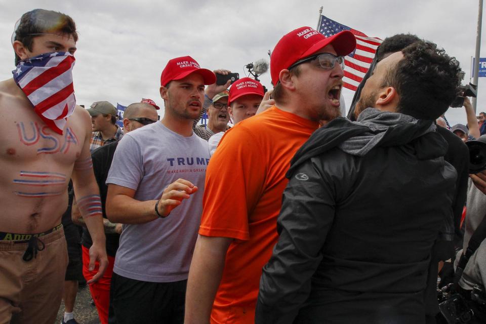 A Trump supporter screams in the face of a protester at a rally on Saturday 