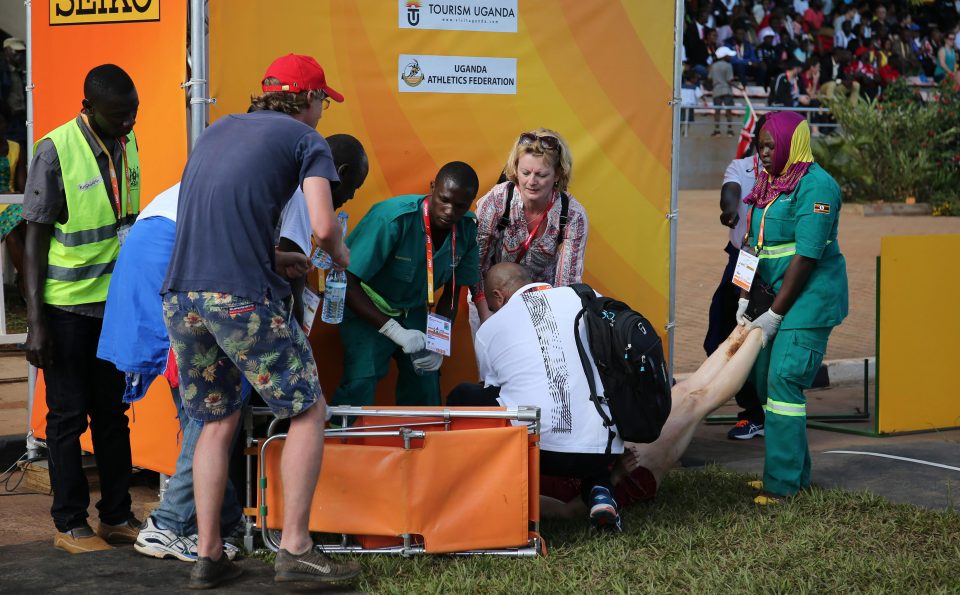  Medics help runner after the Under-20 womens race