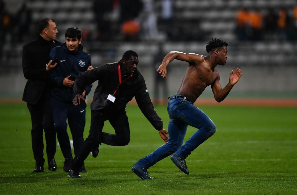  Spectators burst onto the field as security tried stopping them