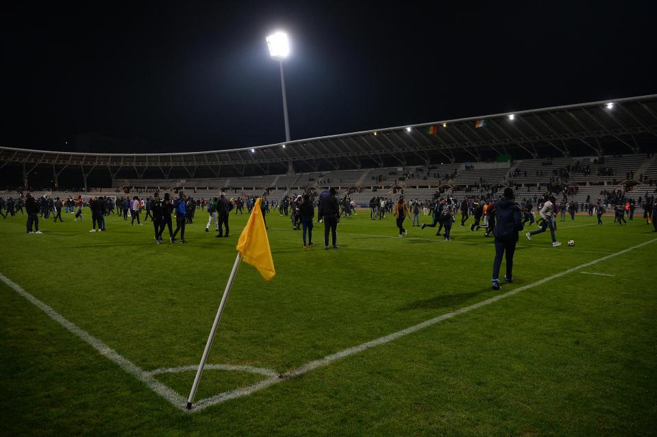  Fans flooded the field as the game was abandoned after 88 minutes