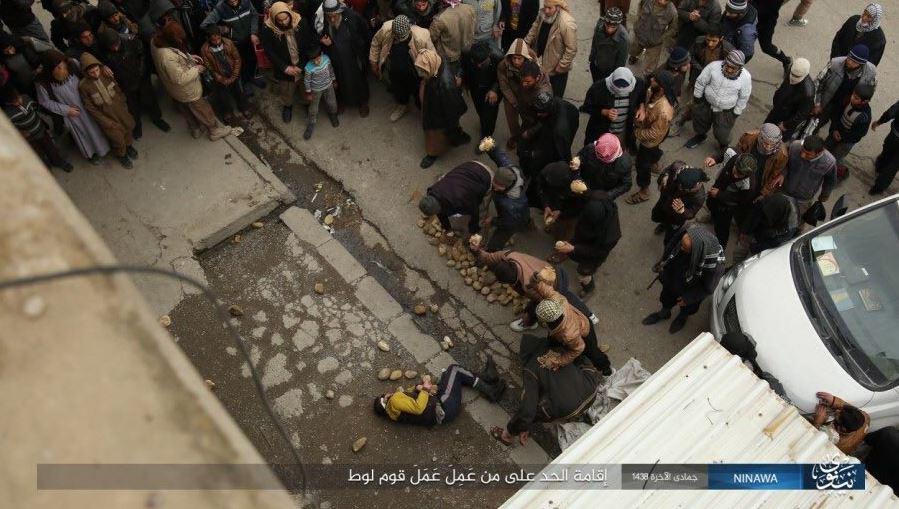  This horrific photo shows the man apparently being pelted with rocks after being thrown from a roof