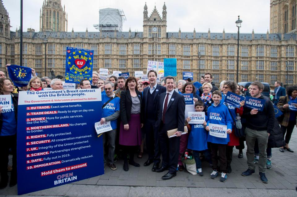  Open Britain protestors demonstrate outside Parliament with Nicky Morgan, left, and Nick Clegg, middle