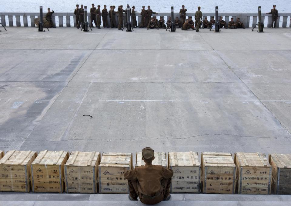  A North Korean official sits by crates of fireworks. Migrant workers face terrible conditions, according to a defector