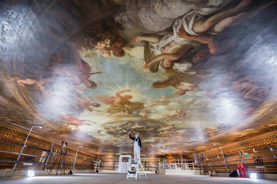 A conservator works on the restoration of Britain’s answer to The Sistine Chapel