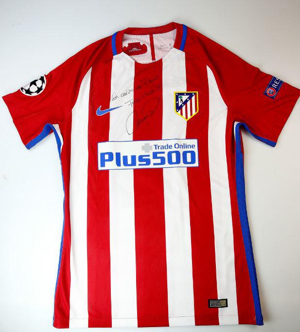 Atletico Madrid forward Fernando Torres added his own signed shirt to the group