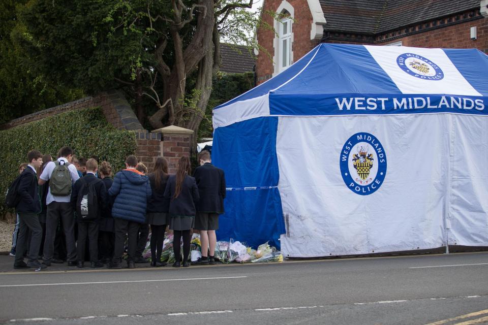  School kids arrive at the scene of the crime to lay flowers and pay tribute to the 13-year-old schoolboy and his mum