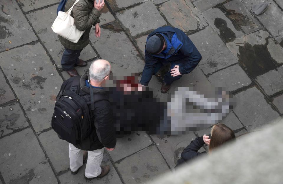  An injured man is assisted after the incident on Westminster Bridge