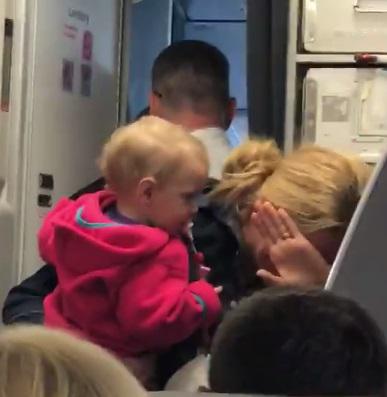  A mum of twins was filmed hysterically crying after accusing a steward of 'hitting' her on board