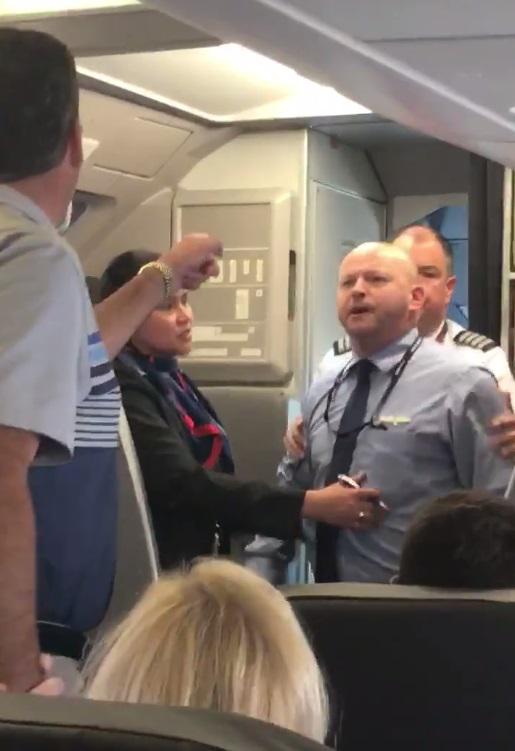  The crew member had to be held back after telling the passenger to 'hit' him