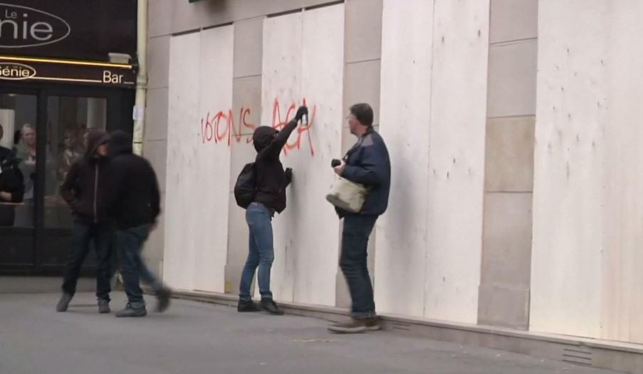  A protester is seen spraying graffiti in the city