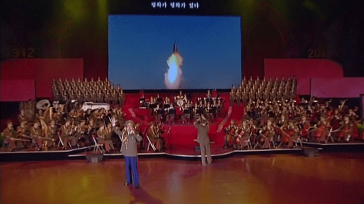  A ballistic missile takes off as an orchestra plays at the Pyongyang concert