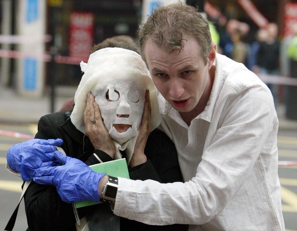  He was seen holding onto Davinia Turrell who had a burns mask on her face, and no shoes