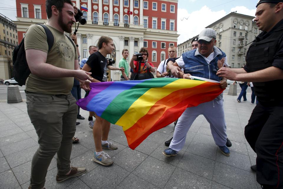  Anti-gay protesters try to tear a rainbow flag during an LGBT community rally in central Moscow, Russia in 2015