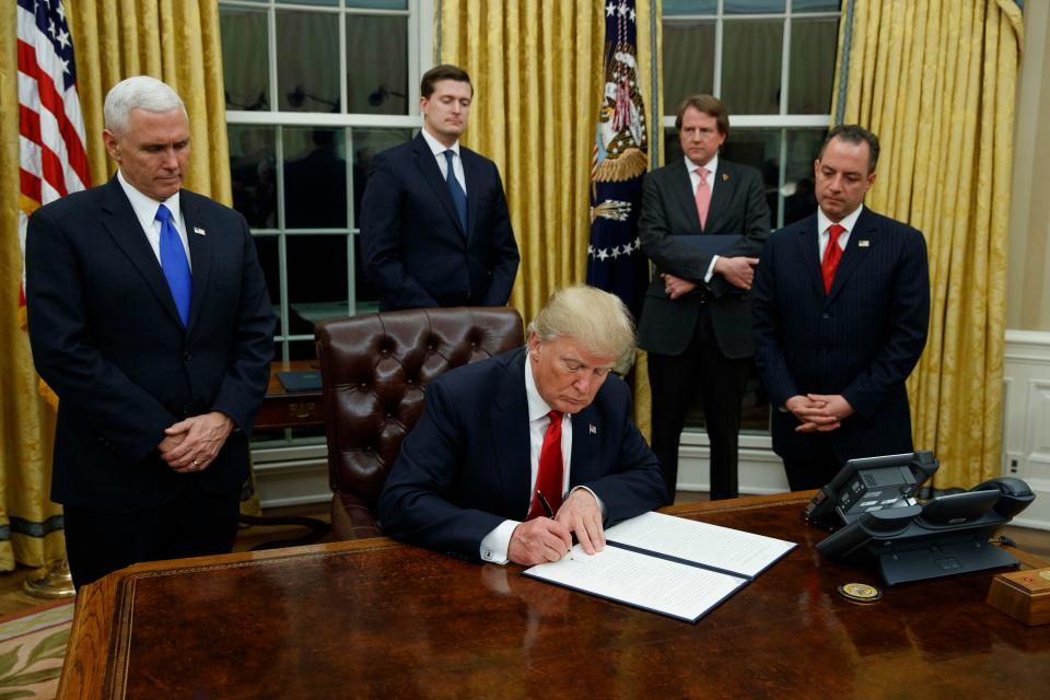 President Donald Trump signs one of his many Executive Orders in the Roosevelt Room of the White House