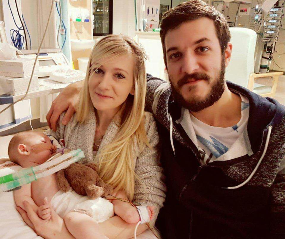  Connie cradles little Charlie in her arms alongside partner Chris Gard as the family smile for the camera