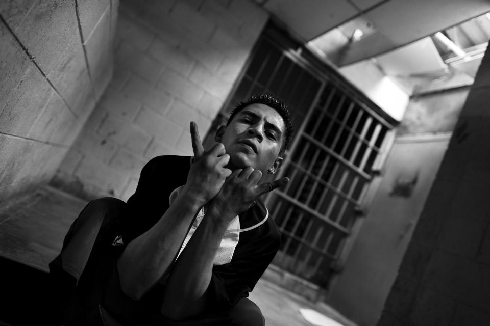  A Mara Salvatrucha gangster shows a hand sign of “Devil's head” in the prison of Tonacatepeque