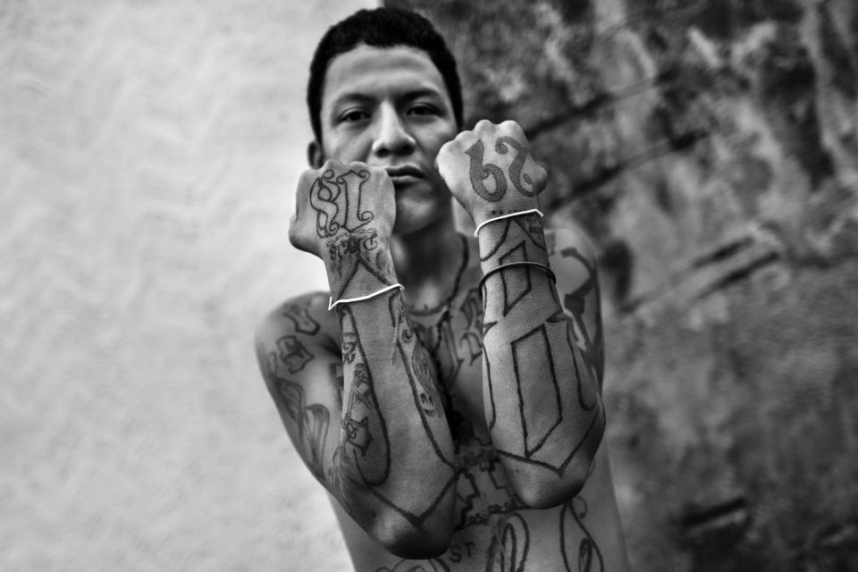  A member of the 18th Street Gang (M-18) proudly shows off his gang tattoos