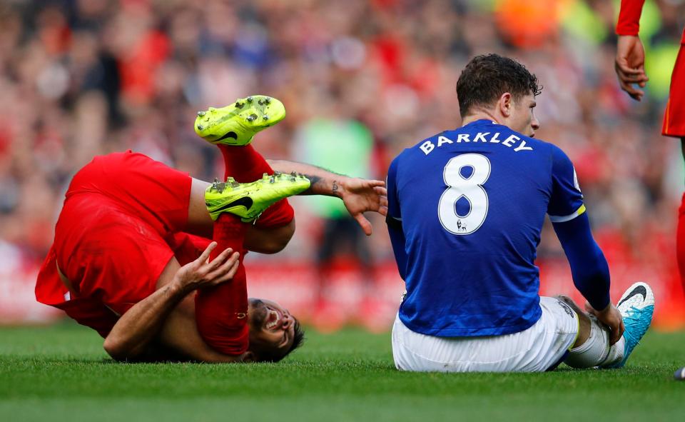  Lovren holds his ankle after the challenge