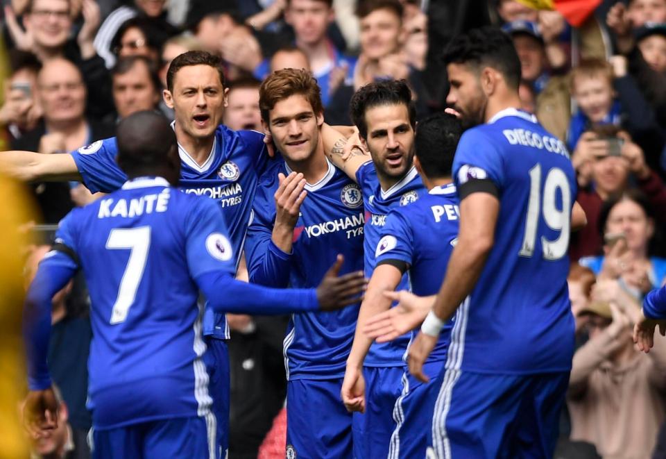  Fabregas is mobbed by his Chelsea teammates after his early goal against Palace