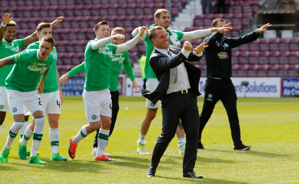  Brendan Rodgers and his Celtic team celebrate their title success at winning the Scottish title