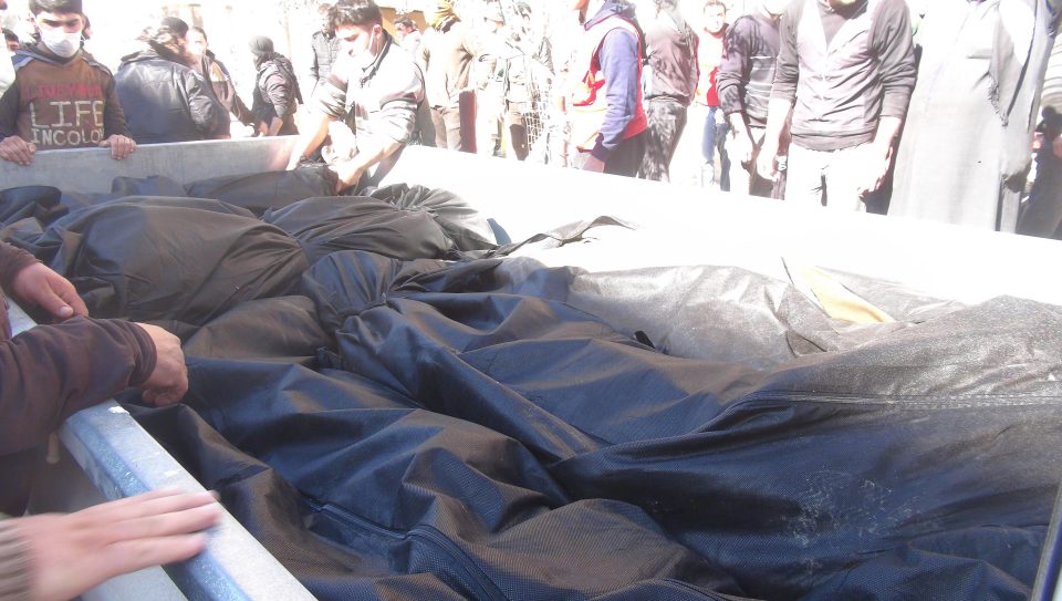  Bodies fill a truck after 100 people were reported to have been killed in the gas attack