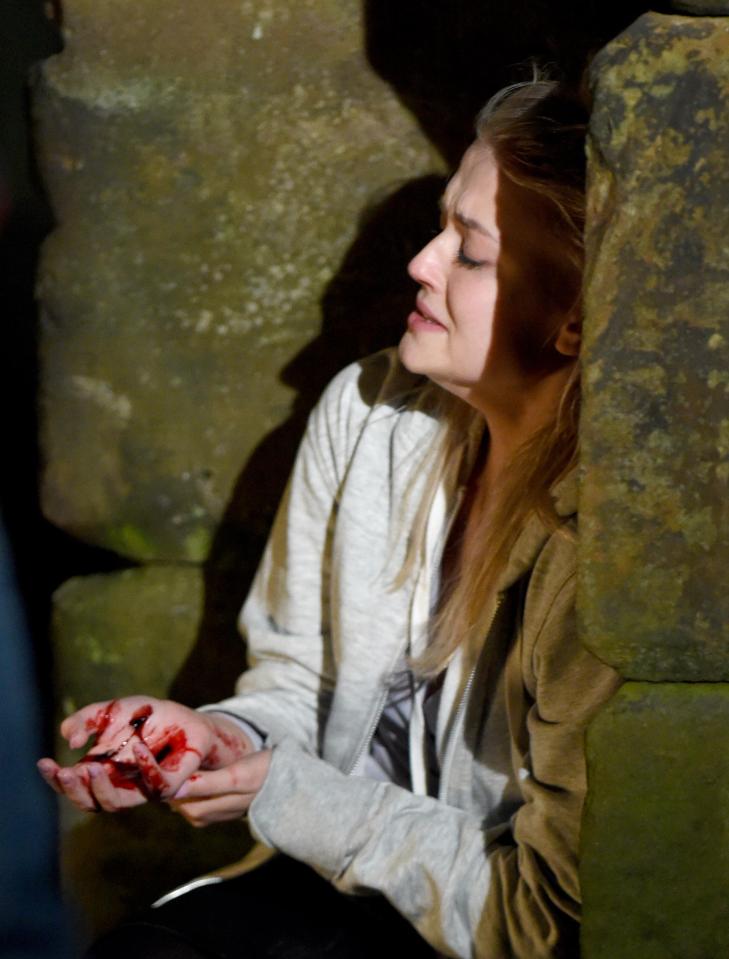  Newly released stills show Bethany, played by Lucy Fallon, sat on a canal path with a deep cut on one hand