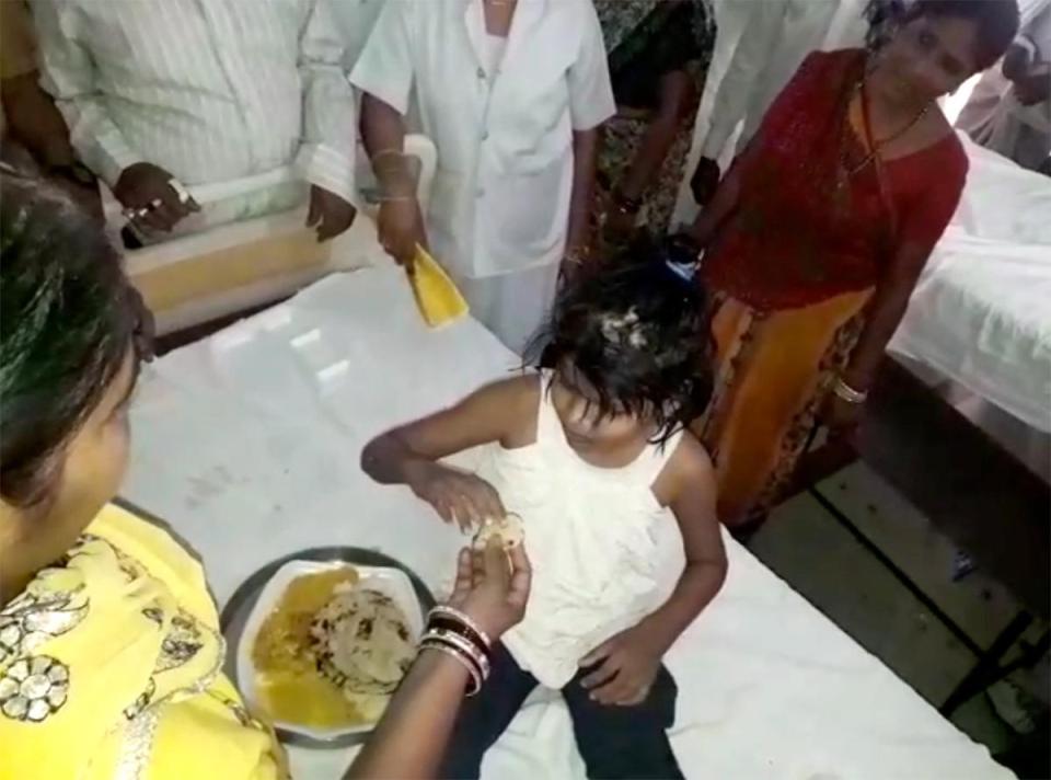  The girl can not eat off a plate and prefers to eat straight off the bed