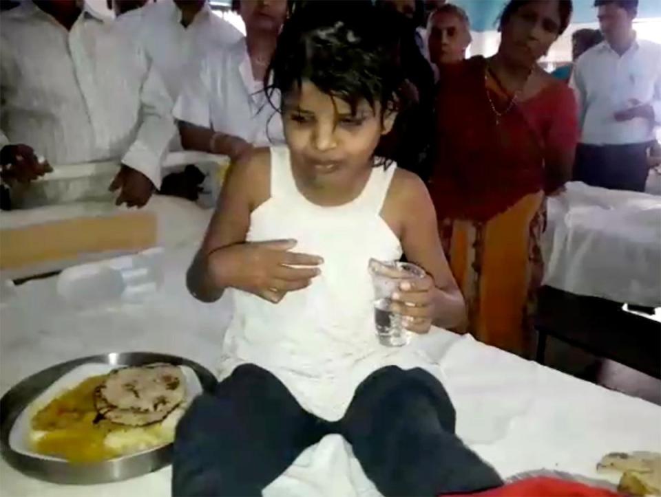  A video shows the youngster clutching a glass of water