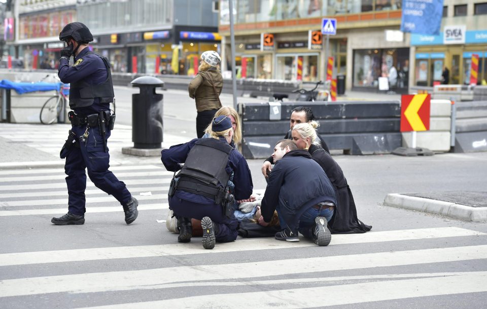  Emergency services tend to an injured victim on the ground