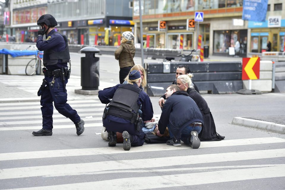  Passersby rush to help a person who was hit in the horrific attack in Sweden's capital