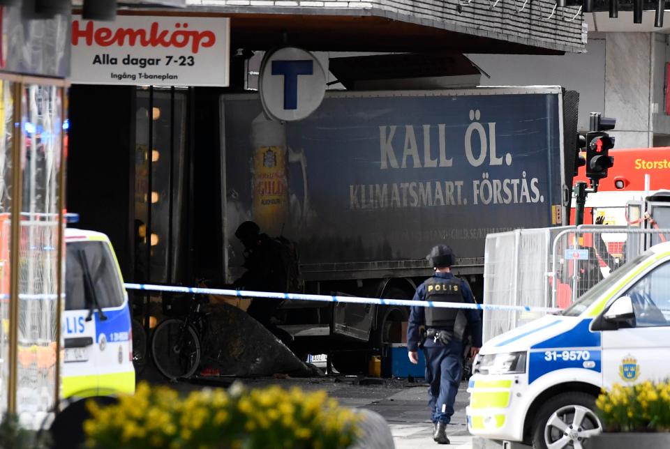  Police cordon off the truck after it crashed into the Ahlens department store at Drottninggatan in central Stockholm on Friday