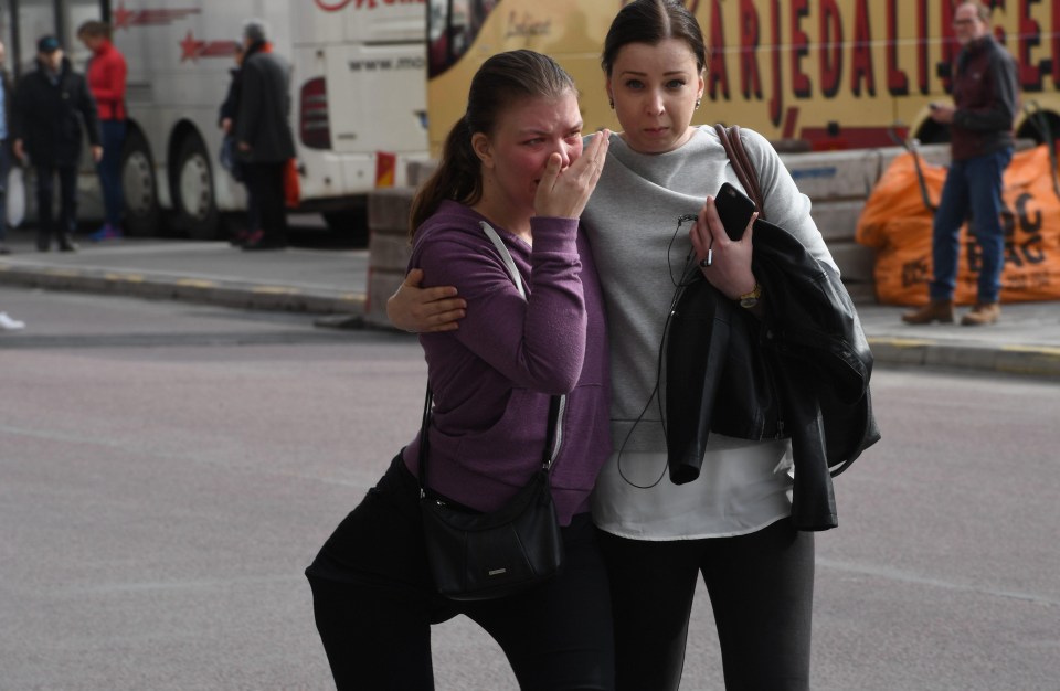 Traumatised witnesses comfort each other after the attack in Sweden this afternoon