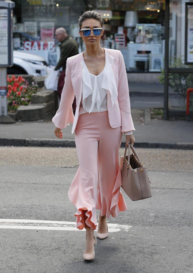  The fashion designer paired a pale pink jacket with wide leg trousers and a ruffle blouse