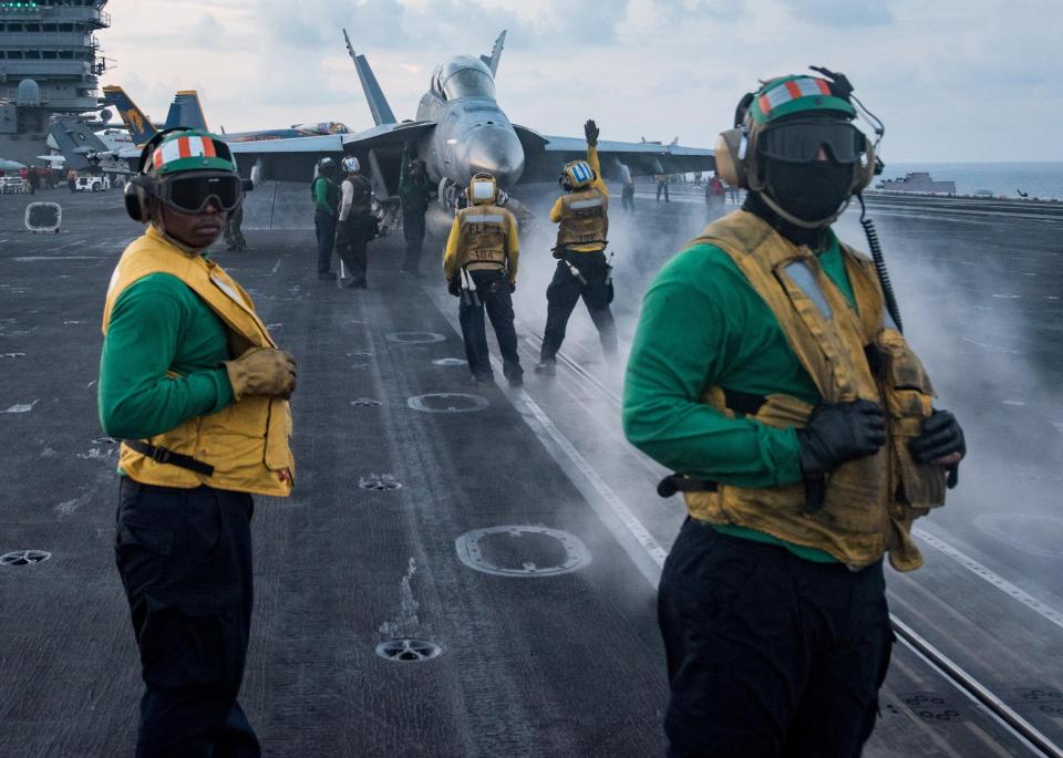  Sailors conduct flight operations on the aircraft carrier USS Carl Vinson (CVN 70) flight deck, in the South China