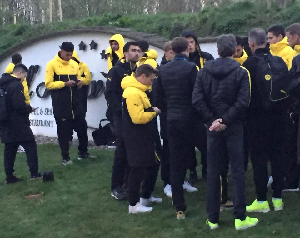  Head coach Thomas Tuchel is surrounded by players after the bus of Borussia Dortmund was damaged after an explosion