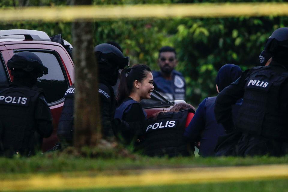  Indonesian Siti Aisyahe is escorted by Malaysian police at the magistrates' court in Sepang, Malaysia