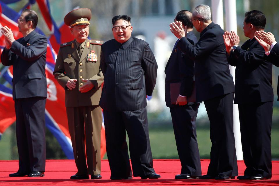  Kim poses next to military officials who form part of his cadre