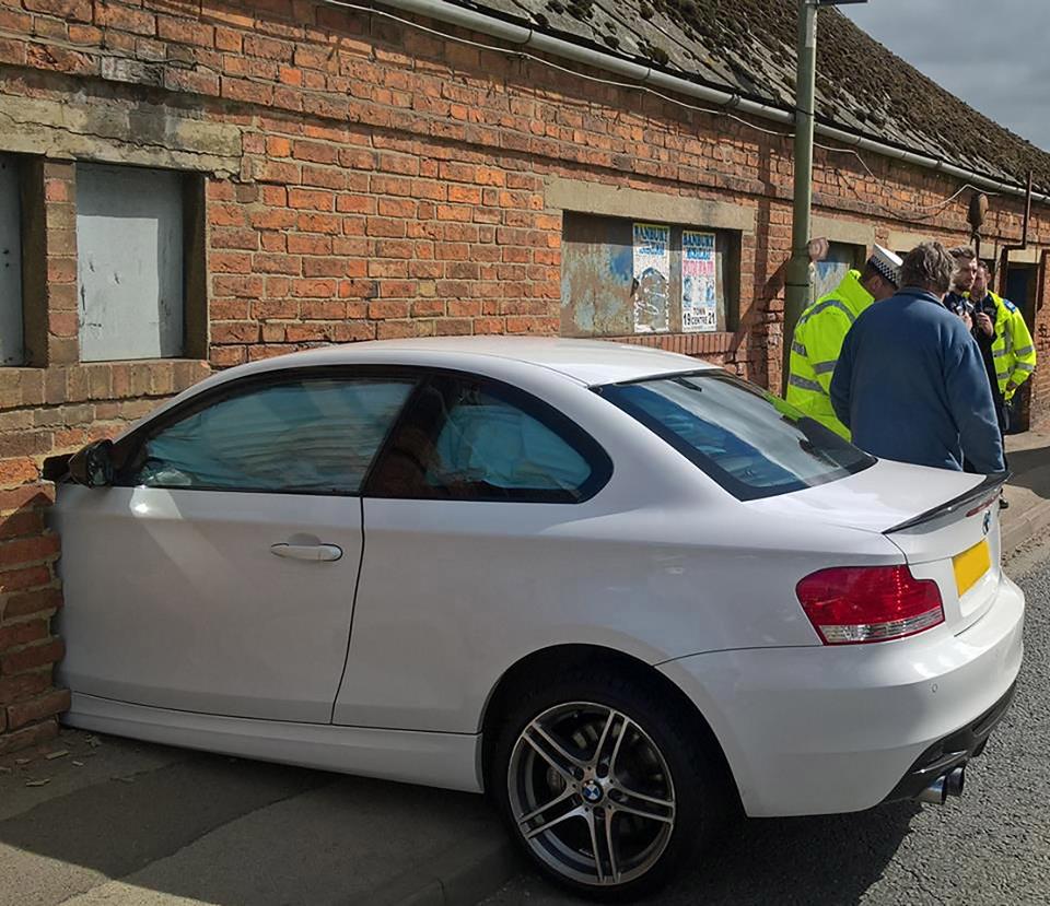  Magic moment ... BMW is wedged in the wall of a factory just like the famous luggage trolley embedded in the wall at Kings Cross station